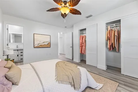 a bedroom with a bed and a chandelier