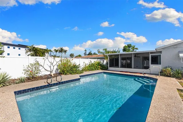 a view of a house with swimming pool and a yard