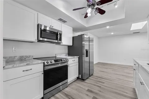 a kitchen with stainless steel appliances a stove microwave and refrigerator