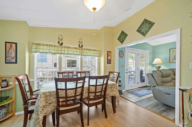 a view of a dining room with furniture and a chandelier