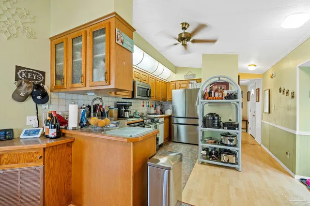 a kitchen that has a lot of cabinets and appliances