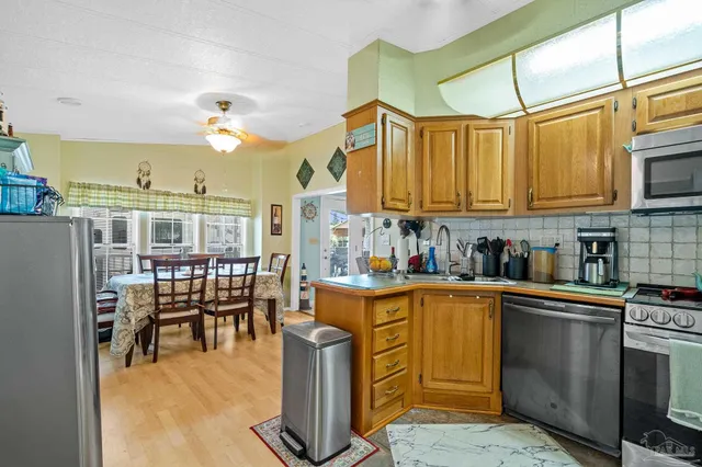 a kitchen with a sink cabinets and window