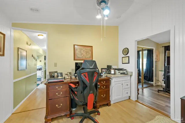 a view of a workspace with furniture and a gym equipment