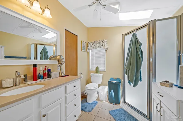 a bathroom with a double vanity sink mirror and toilet