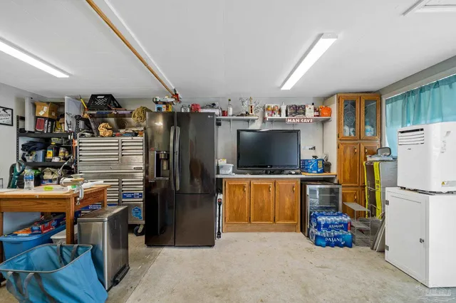 a kitchen with refrigerator and cabinets
