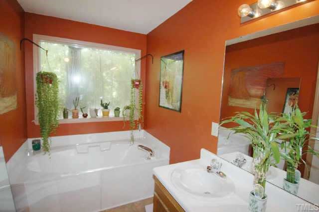 2105 Bufflehead Road Raleigh, NC 27616 - Photo 11 of 12 a bathroom with a sink mirror and a bathtub