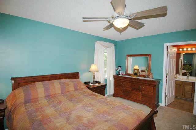 2105 Bufflehead Road Raleigh, NC 27616 - Photo 12 of 12 a bed room with a bed and a chandelier