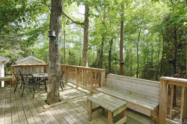 2105 Bufflehead Road Raleigh, NC 27616 - Photo 3 of 12 a view of a patio with table and chairs with wooden floor and fence