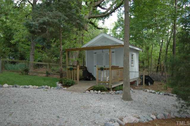 2105 Bufflehead Road Raleigh, NC 27616 - Photo 5 of 12 a view of a small house with a yard and large tree