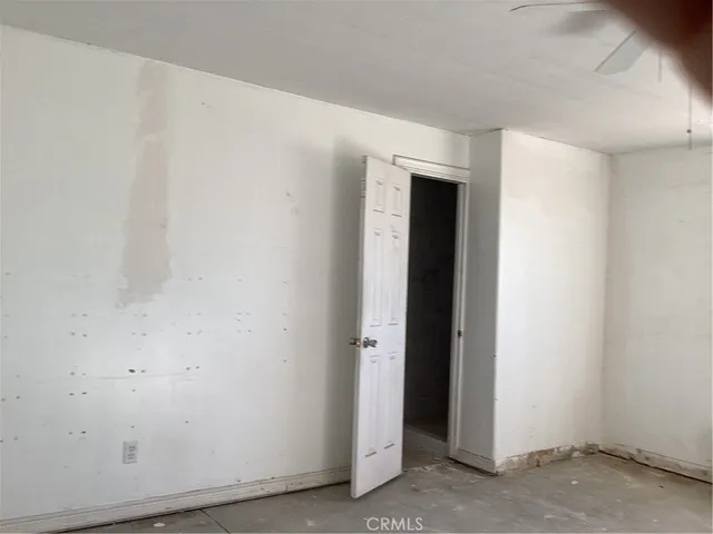 a kitchen with white cabinets and sink