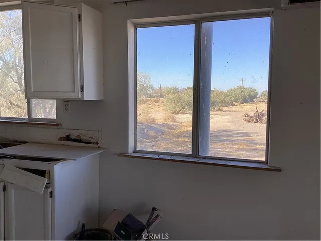a kitchen with a sink window and cabinets