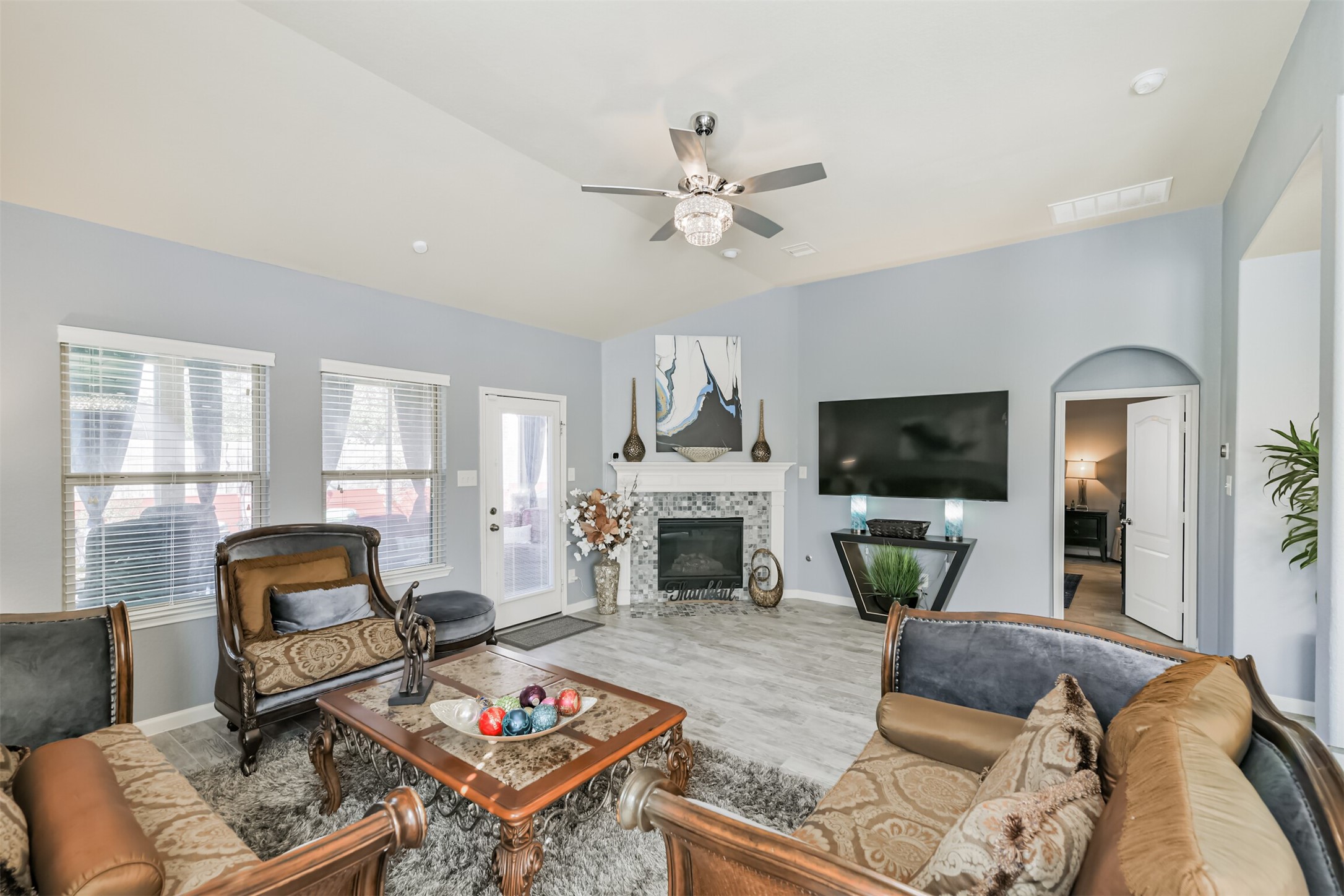 24047 Schults Meadow Lane Spring, TX 77389 - Photo 8 of 47 a living room with furniture a fireplace a flat screen tv and a large window