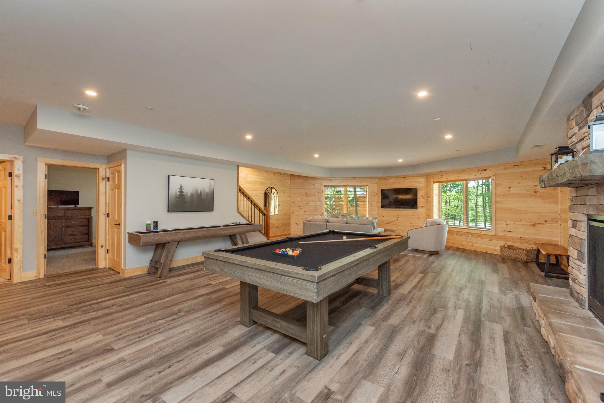 110 Wisp Adventure Road McHenry, MD 21541 - Photo 34 of 73 a living room with furniture a flat screen tv and a floor to ceiling window