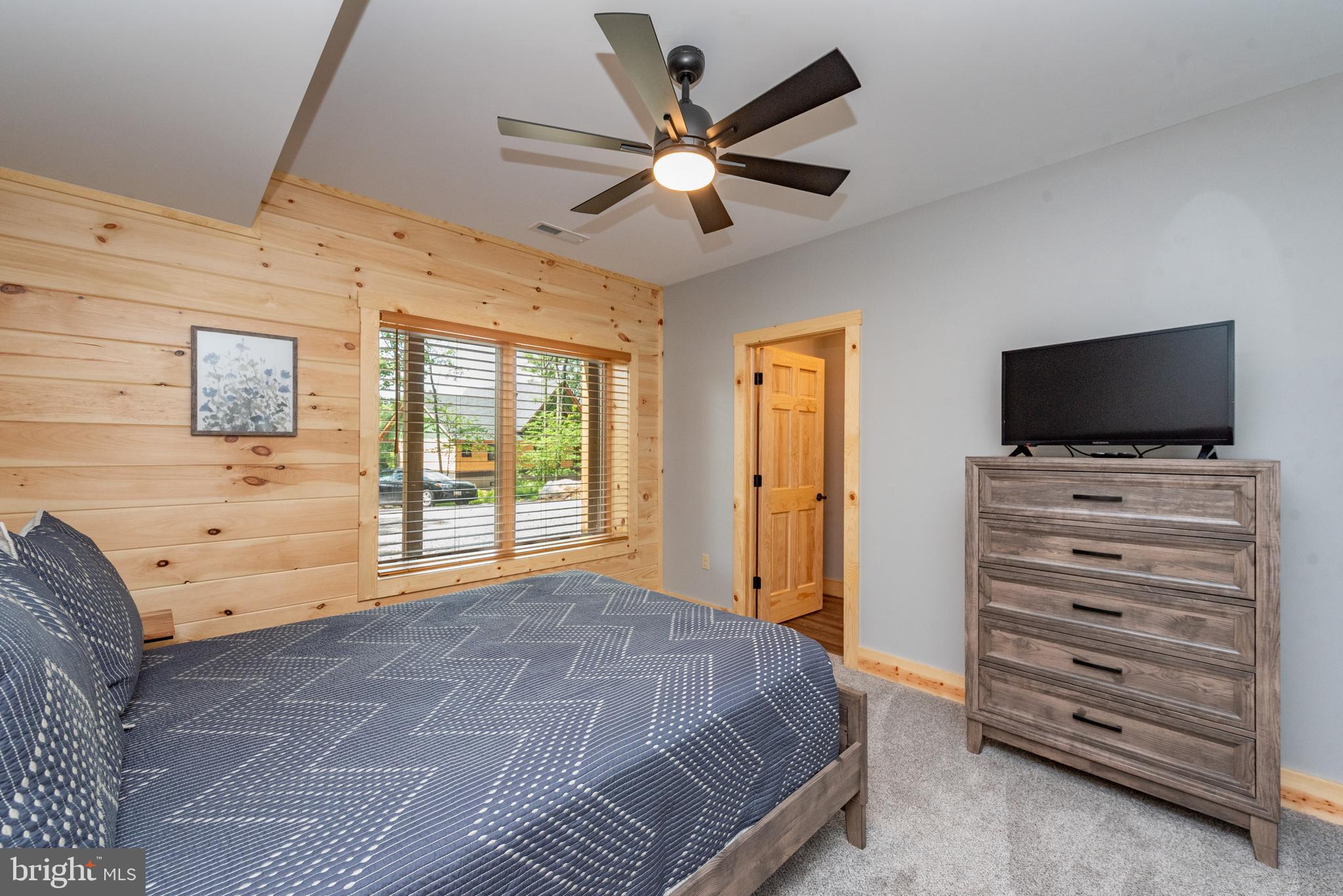 110 Wisp Adventure Road McHenry, MD 21541 - Photo 46 of 73 a bedroom with a bed and a flat screen tv
