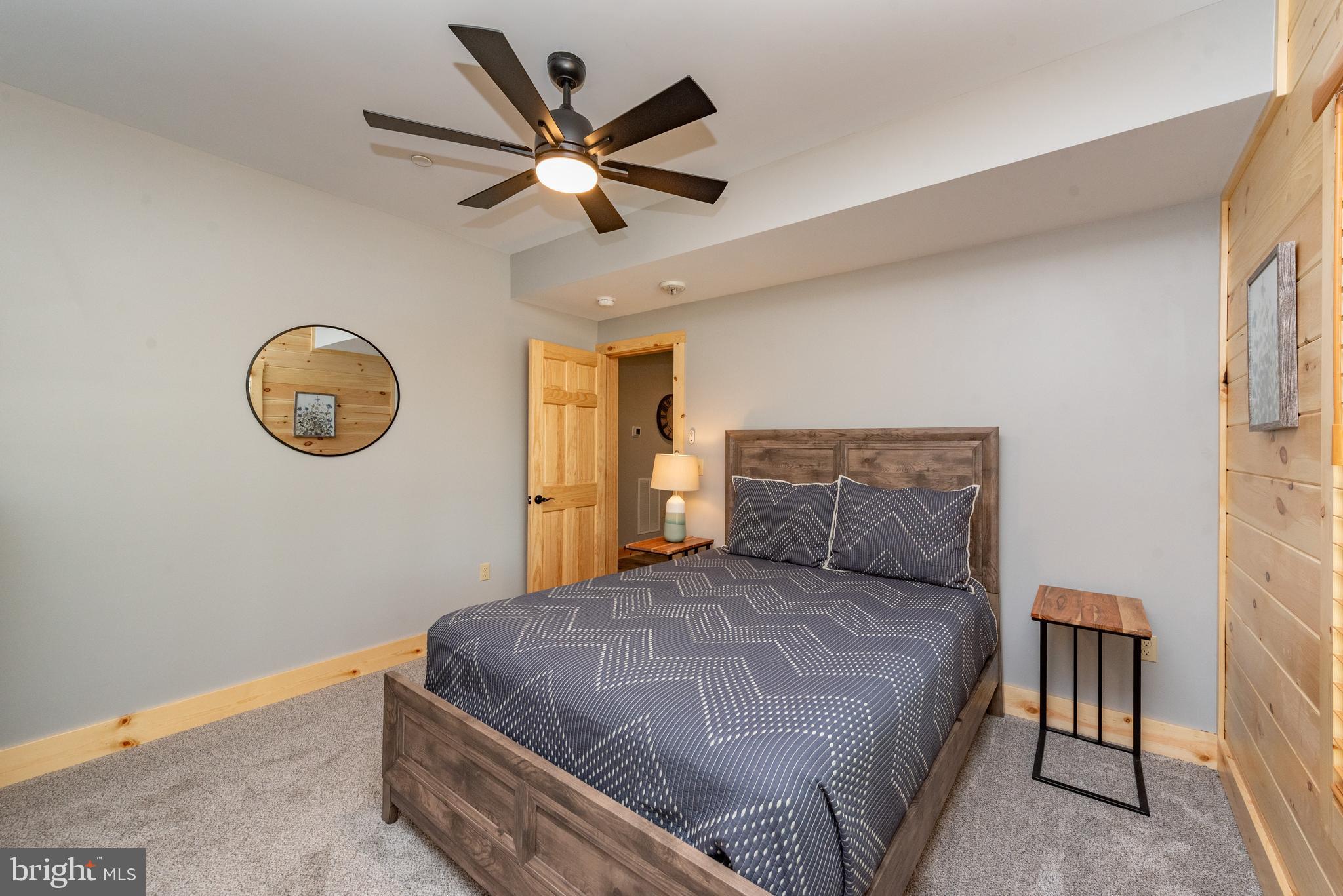110 Wisp Adventure Road McHenry, MD 21541 - Photo 48 of 73 a bedroom with a bed and a chandelier