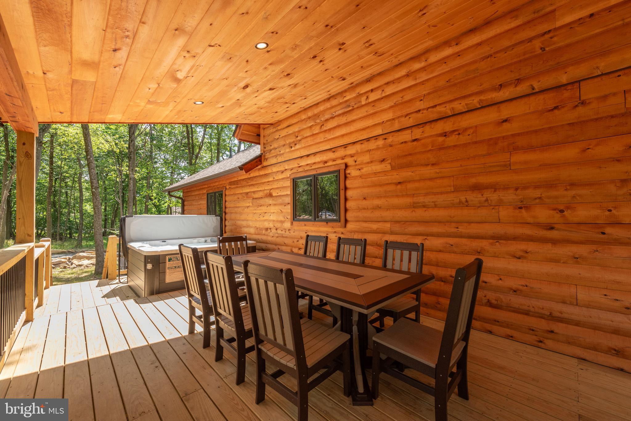 110 Wisp Adventure Road McHenry, MD 21541 - Photo 67 of 73 a view of a patio with table and chairs with wooden floor and fence