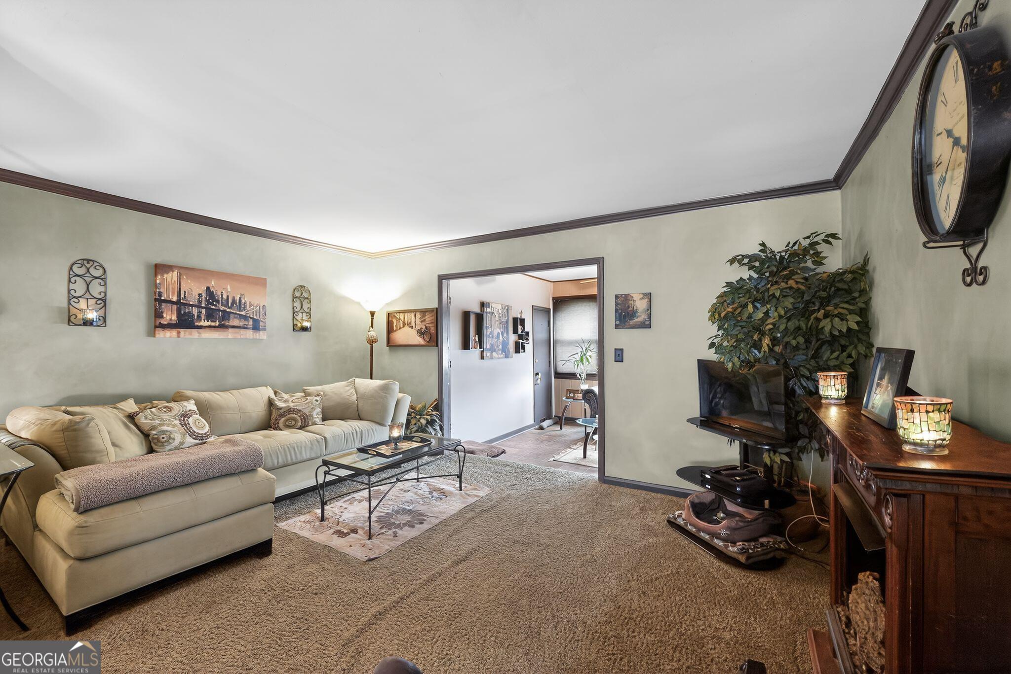 68 Montre Square Northwest Atlanta, GA 30327 - Photo 4 of 16 a living room with furniture and a flat screen tv