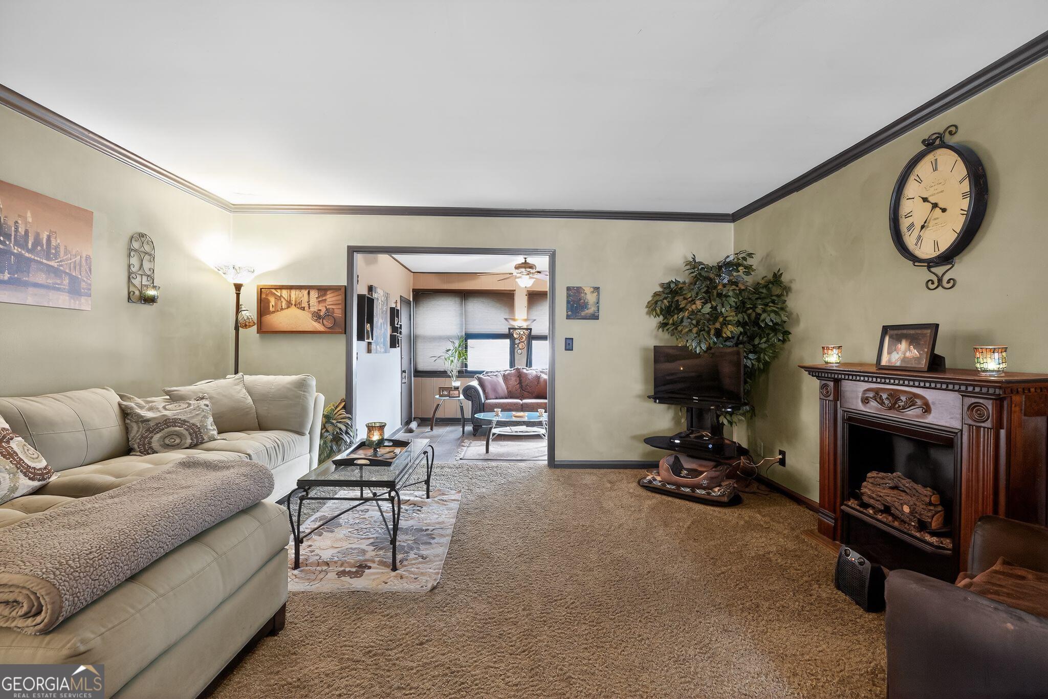 68 Montre Square Northwest Atlanta, GA 30327 - Photo 5 of 16 a living room with furniture a clock and a fireplace