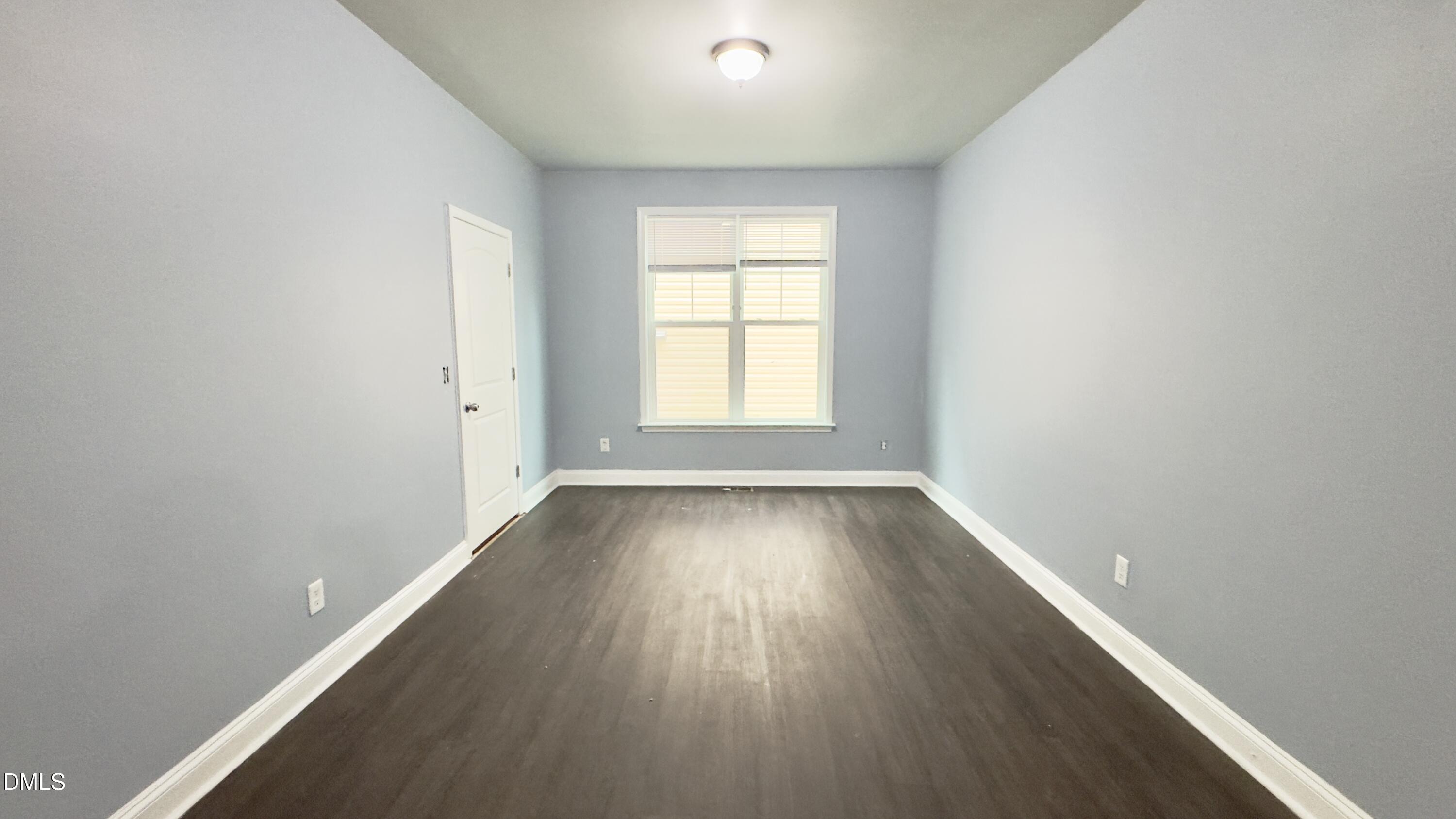 5401 Razan Street Raleigh, NC 27616 - Photo 10 of 30 an empty room with wooden floor and windows