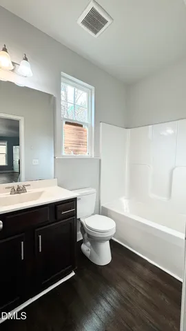 a bathroom with a double vanity sink toilet and shower