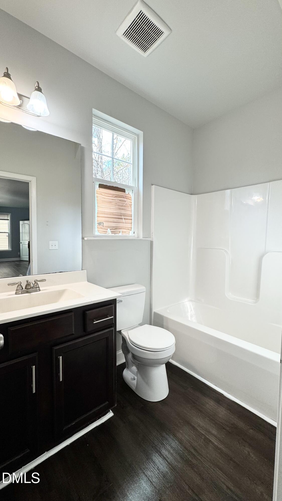 5401 Razan Street Raleigh, NC 27616 - Photo 11 of 30 a bathroom with a double vanity sink toilet and shower