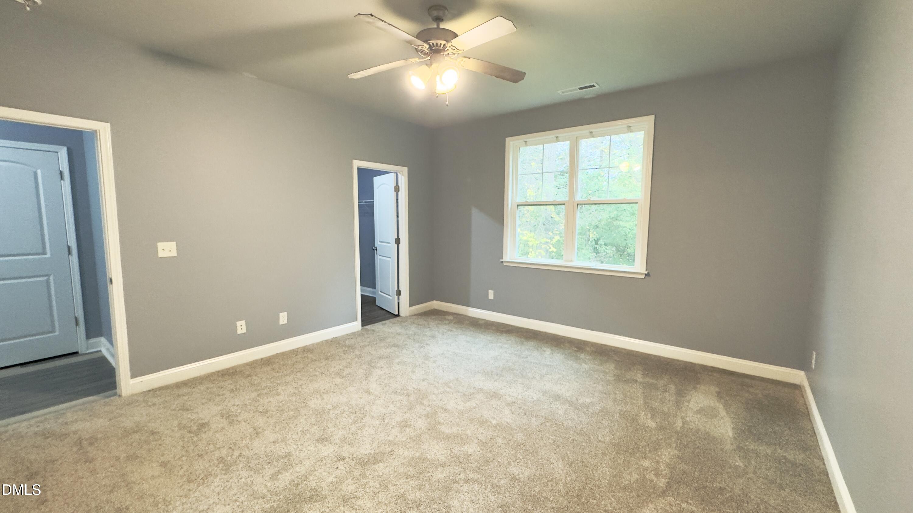 5401 Razan Street Raleigh, NC 27616 - Photo 14 of 30 an empty room with windows and fan