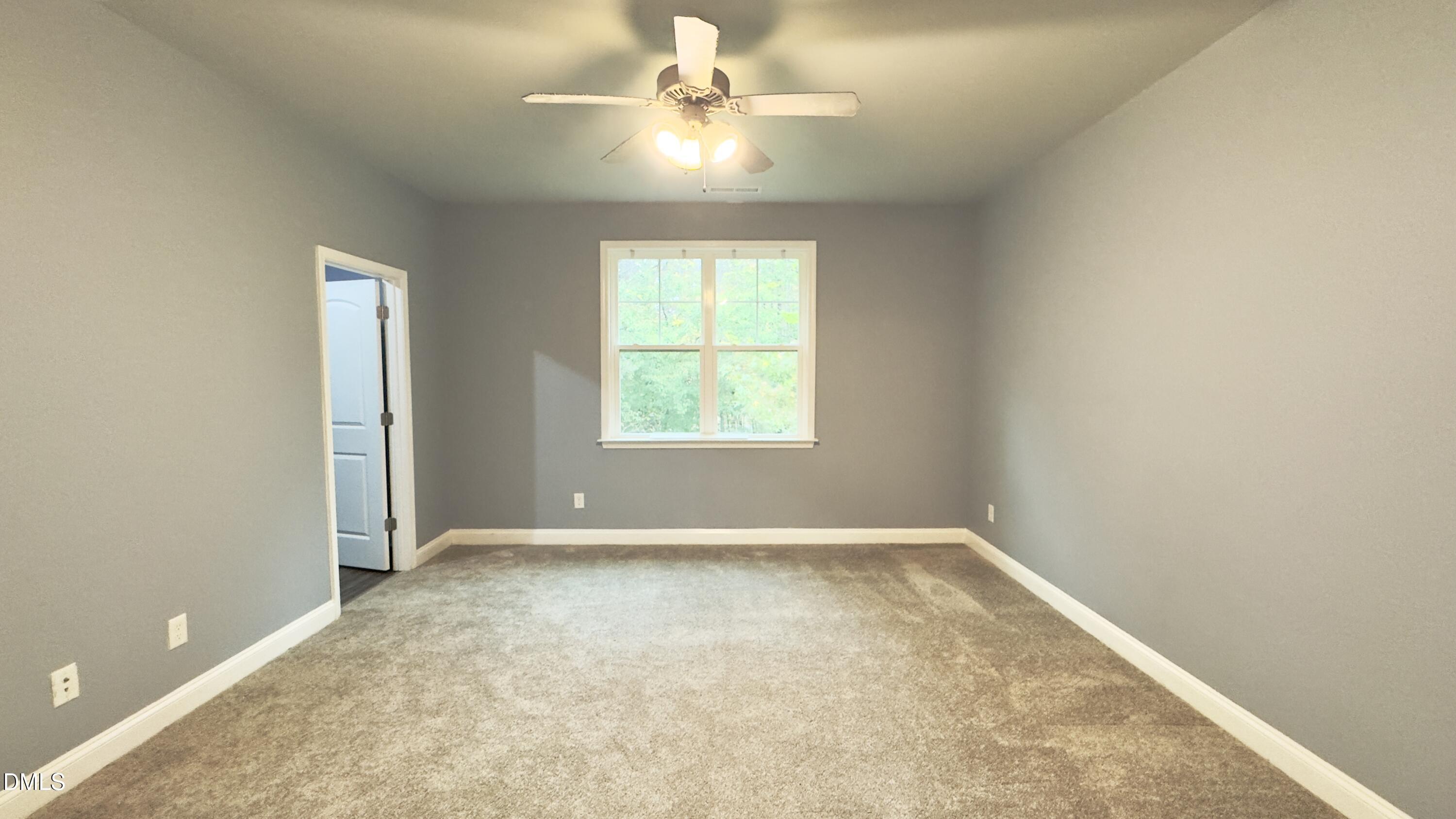5401 Razan Street Raleigh, NC 27616 - Photo 15 of 30 an empty room with windows and fan