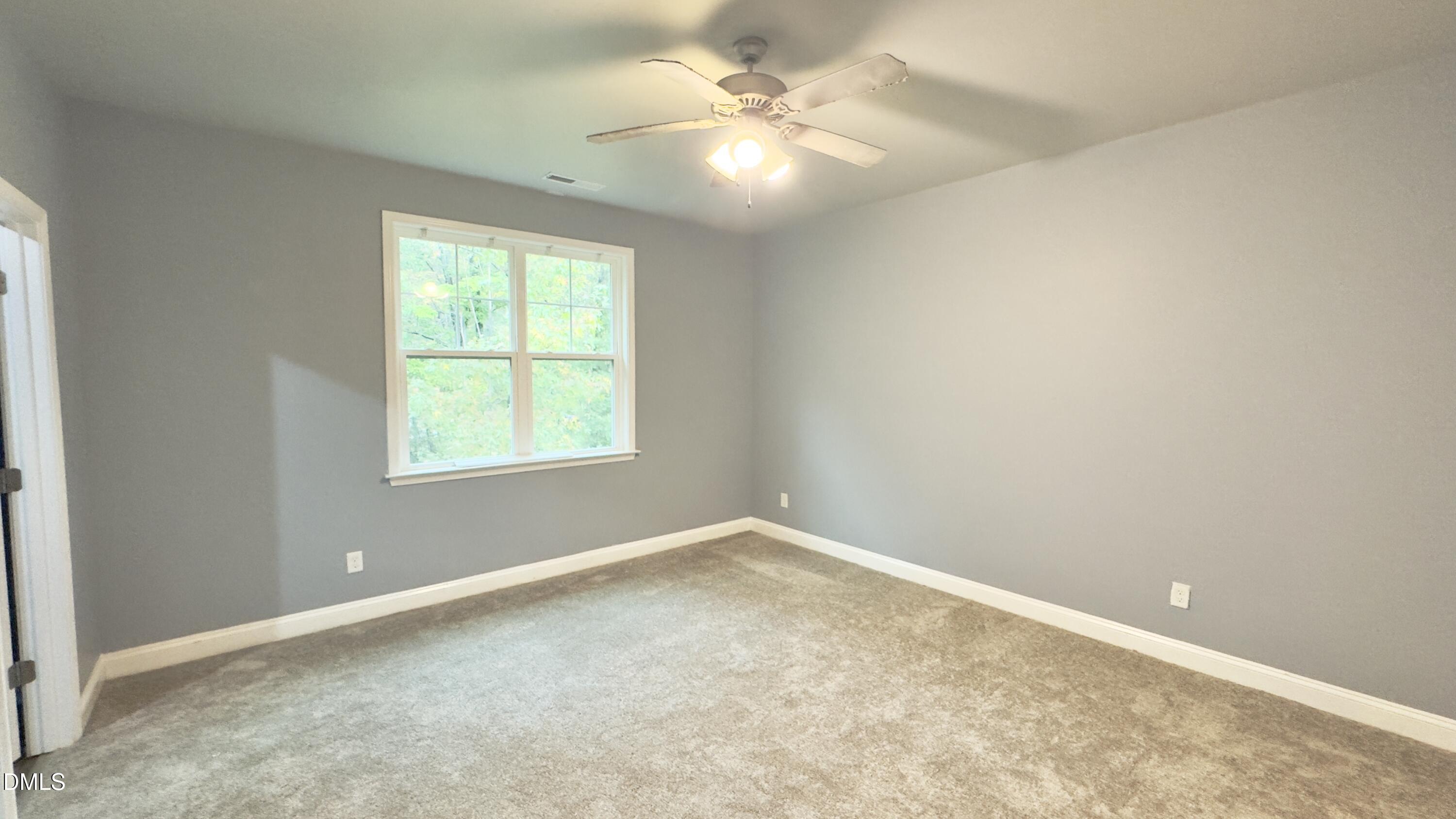 5401 Razan Street Raleigh, NC 27616 - Photo 16 of 30 an empty room with windows and fan
