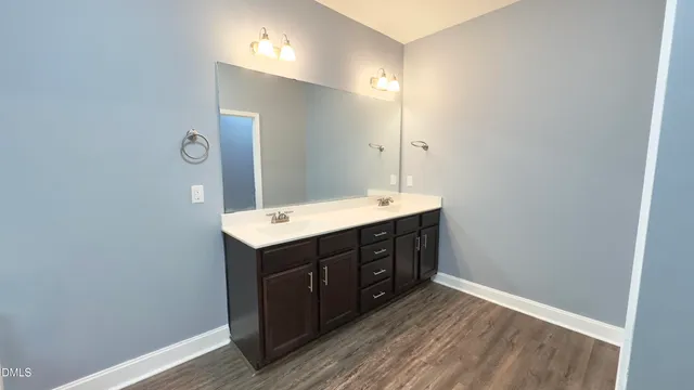 a bathroom with a sink vanity and mirror