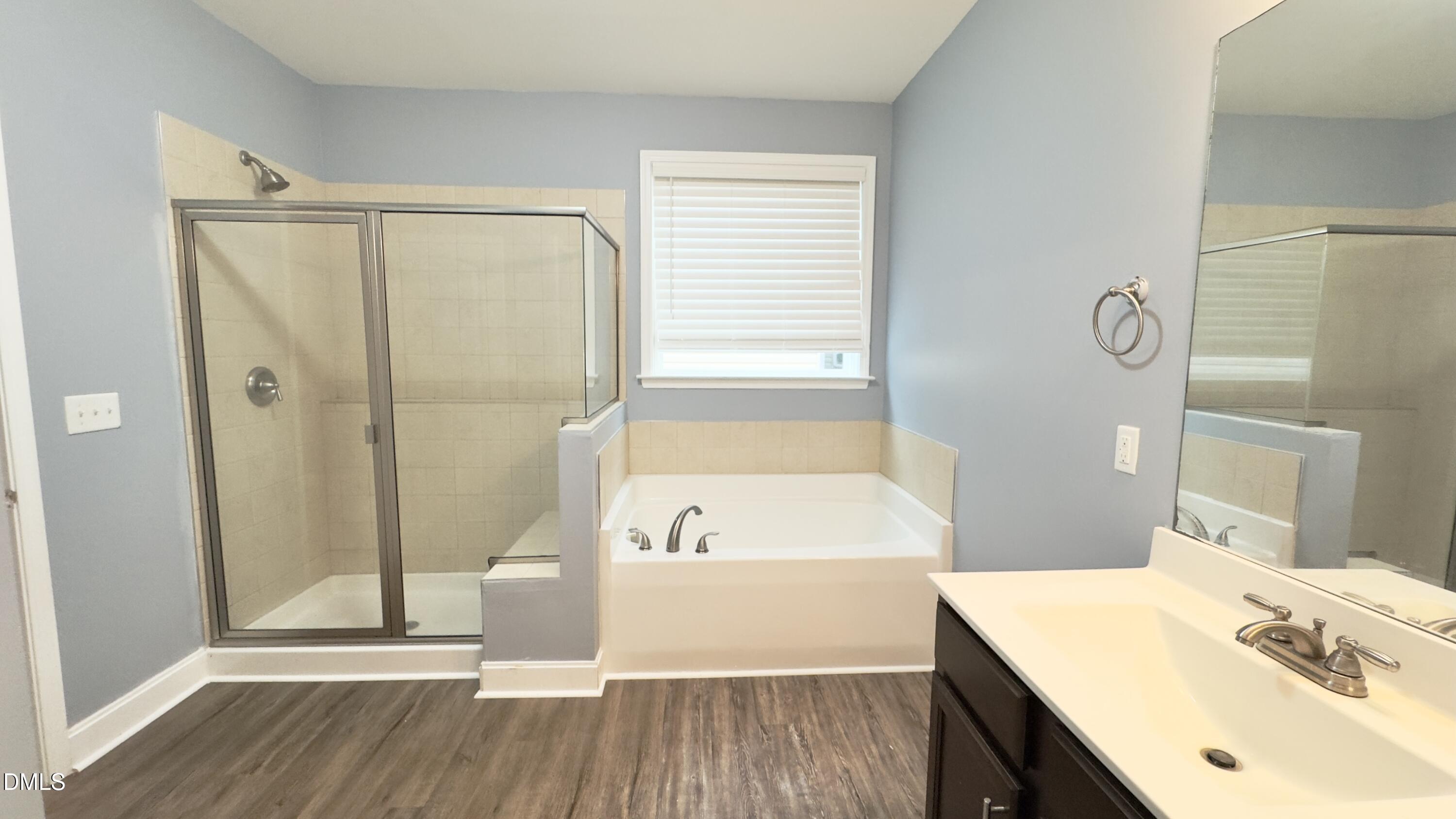 5401 Razan Street Raleigh, NC 27616 - Photo 20 of 30 a bathroom with a tub shower vanity and a sink