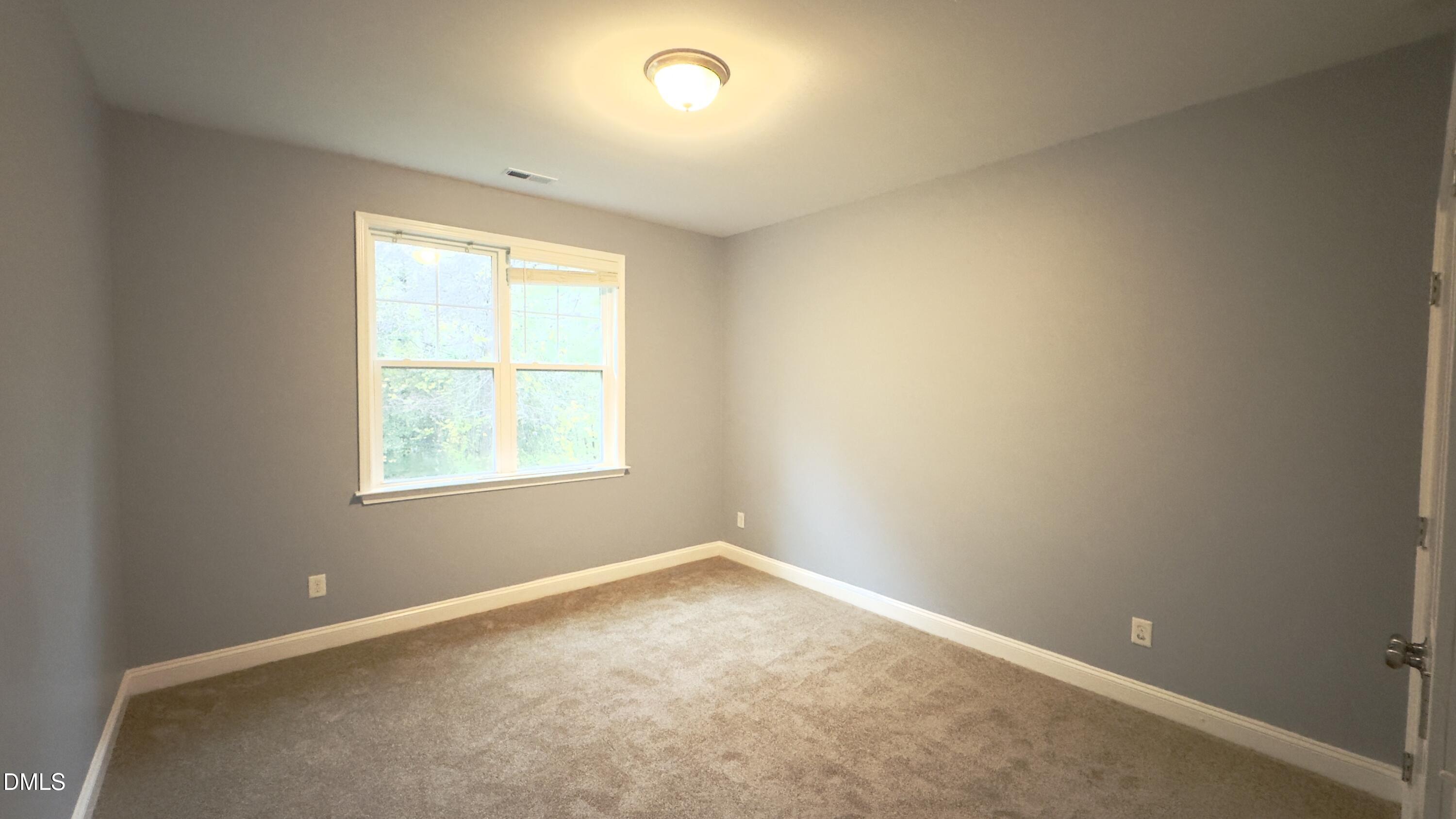 5401 Razan Street Raleigh, NC 27616 - Photo 21 of 30 an empty room with a window