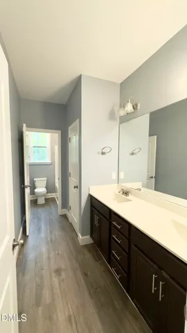 a spacious bathroom with a double vanity sink and a mirror