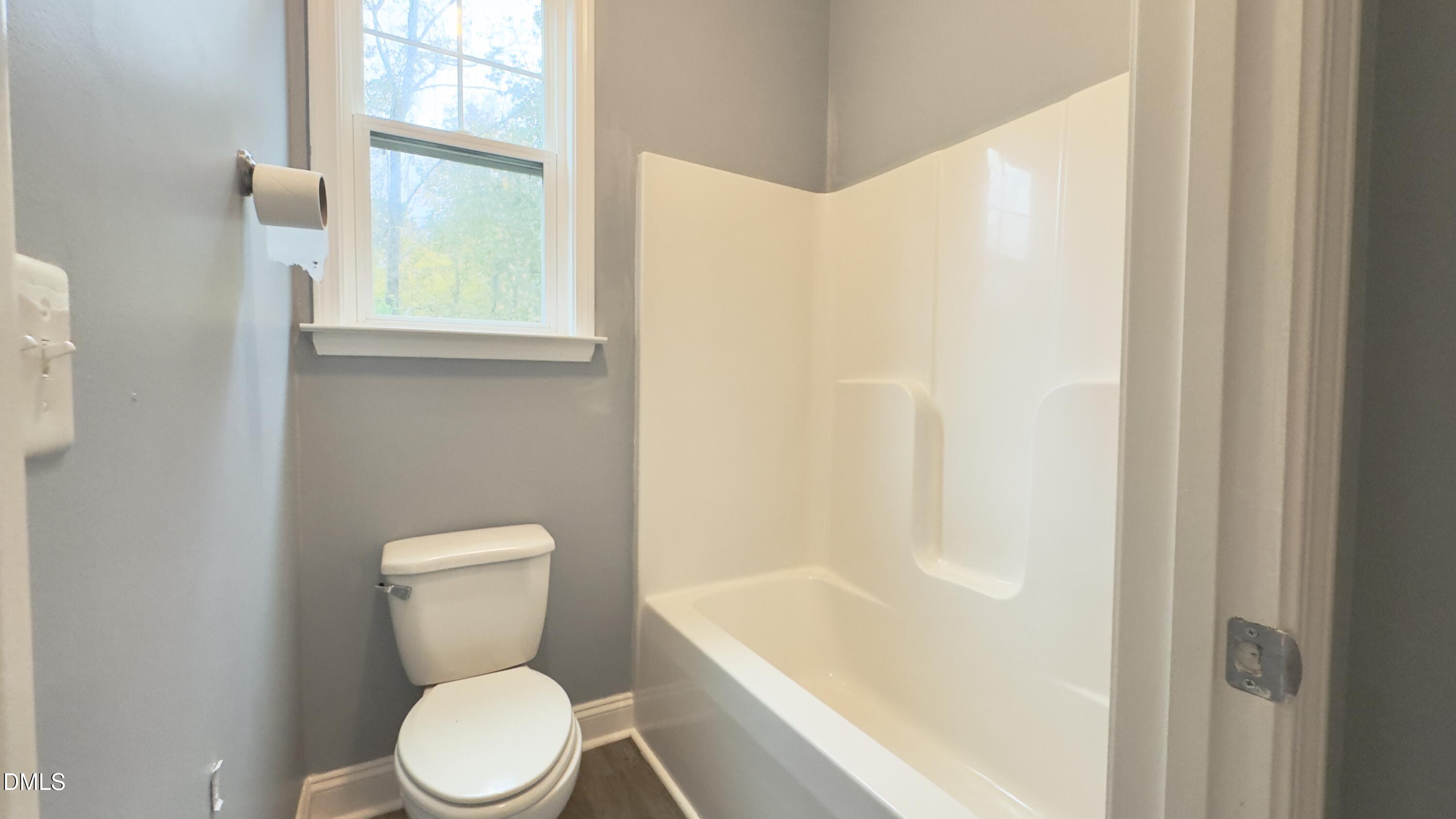5401 Razan Street Raleigh, NC 27616 - Photo 26 of 30 a white toilet sitting next to a bathroom sink
