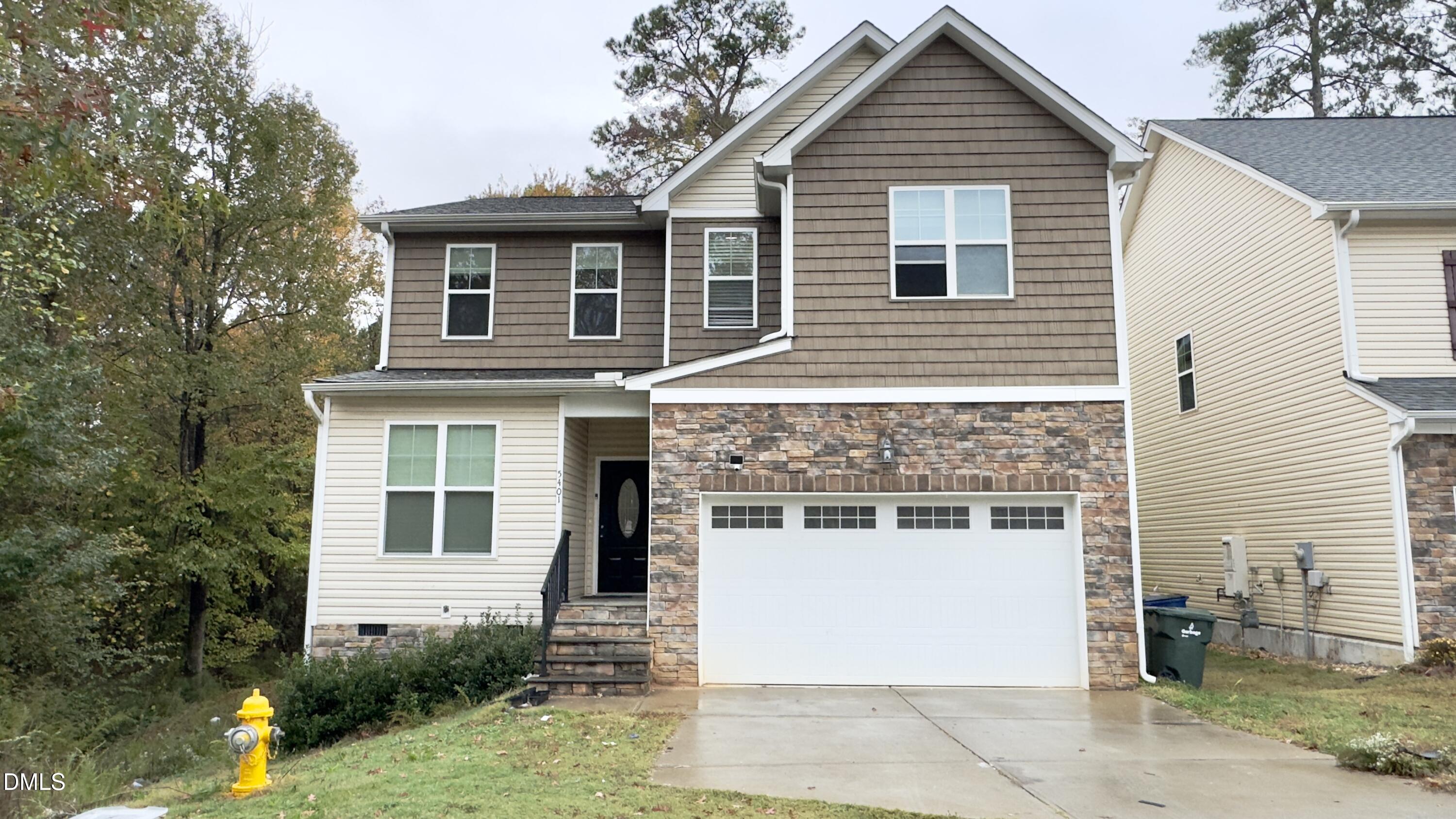 5401 Razan Street Raleigh, NC 27616 - Photo 2 of 30 a front view of a house with a garden and plants