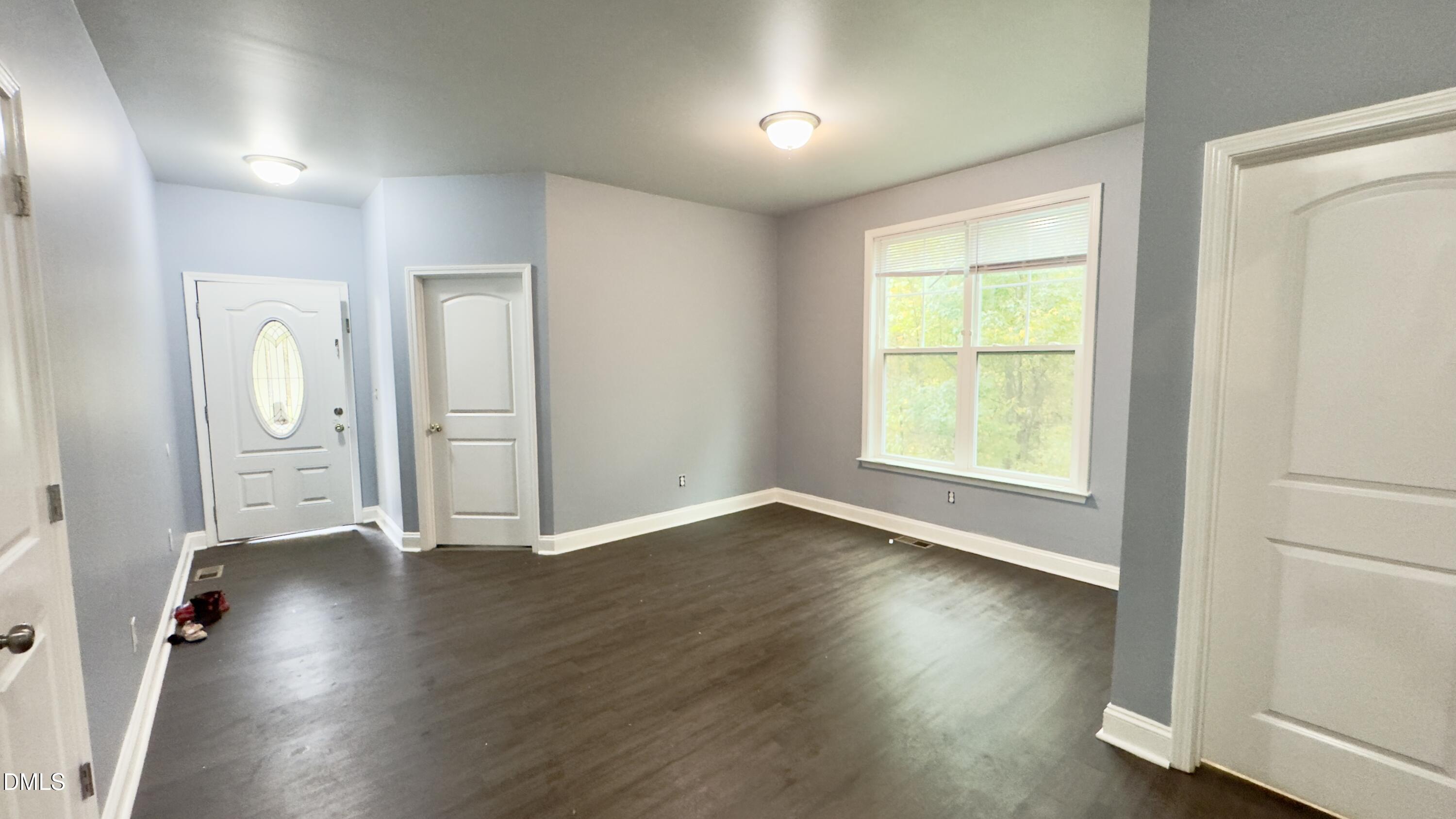 5401 Razan Street Raleigh, NC 27616 - Photo 4 of 30 an empty room with wooden floor and windows