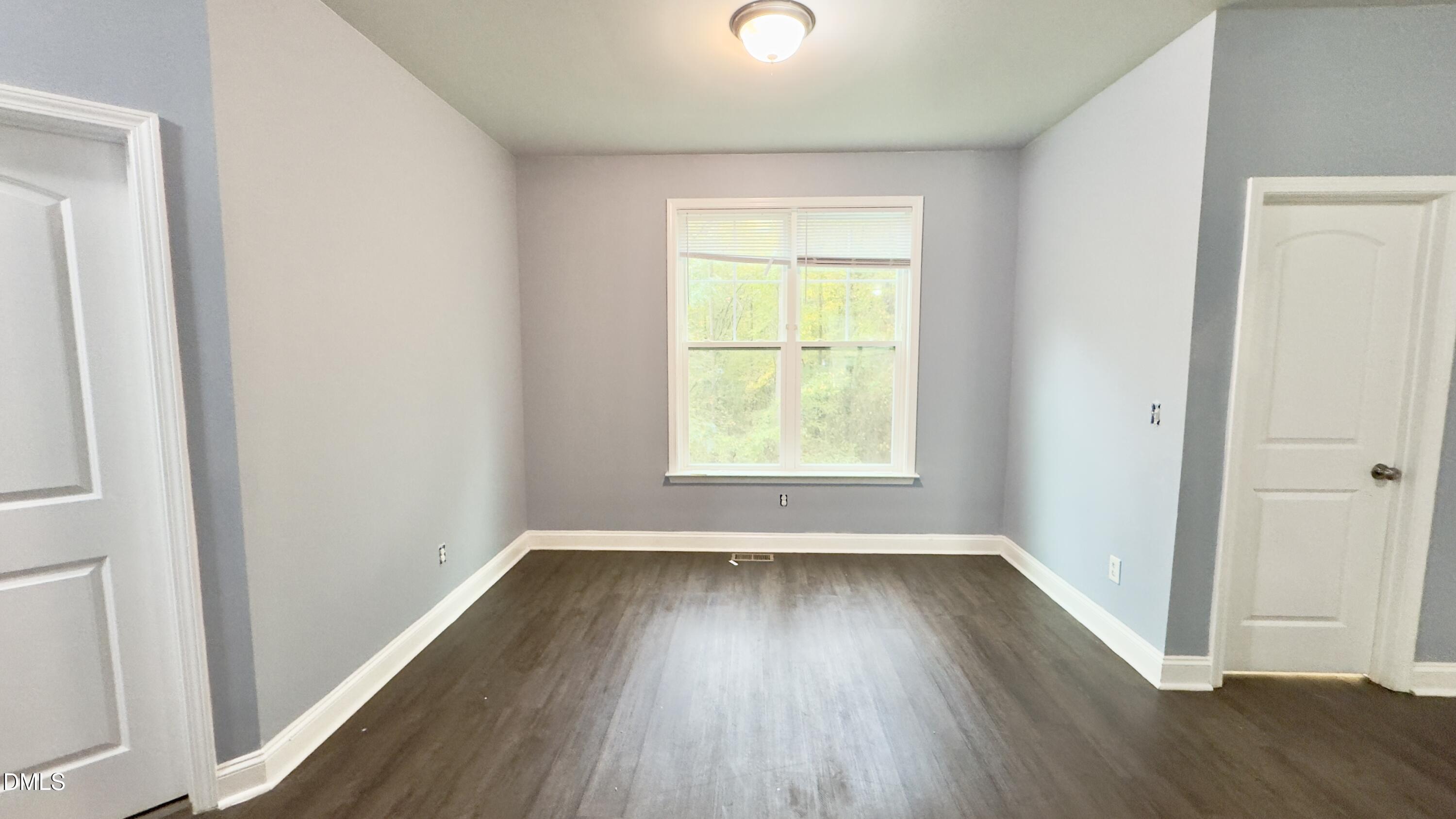 5401 Razan Street Raleigh, NC 27616 - Photo 5 of 30 an empty room with wooden floor and windows