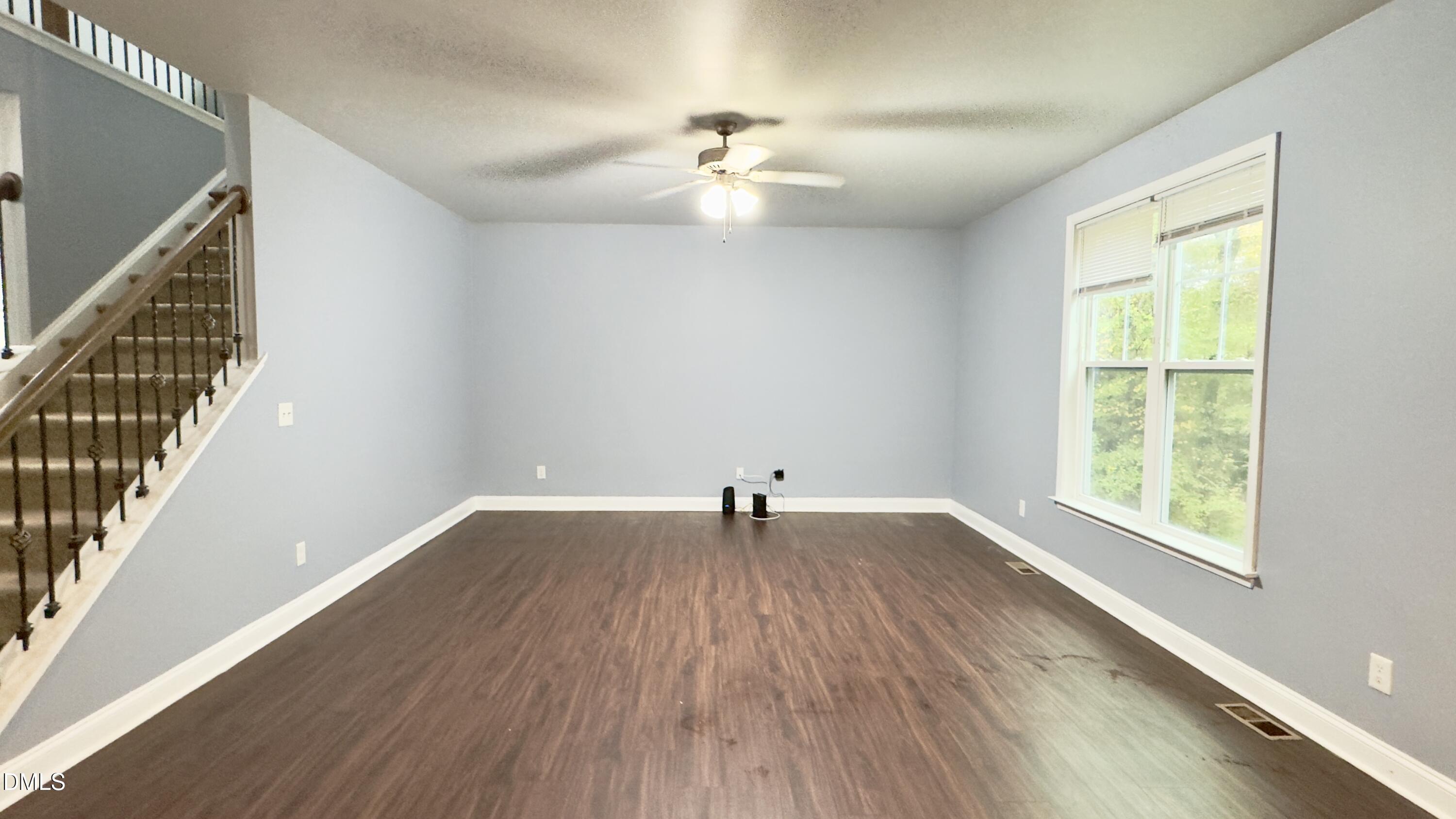 5401 Razan Street Raleigh, NC 27616 - Photo 8 of 30 a view of an empty room with wooden floor and a window