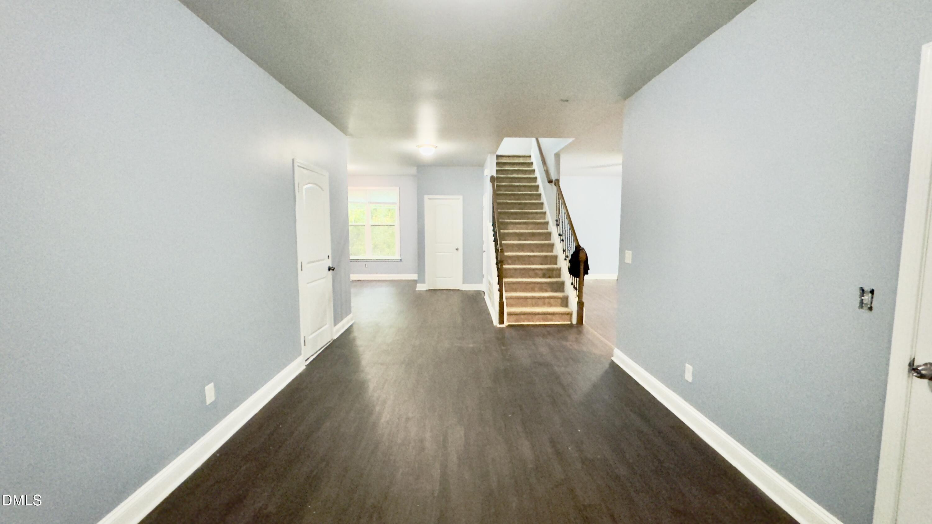 5401 Razan Street Raleigh, NC 27616 - Photo 9 of 30 a view of a hallway with wooden floor