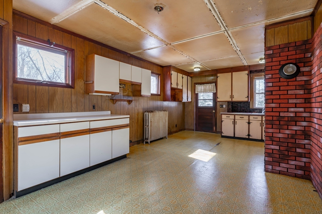 34 Summer Street Saugus, MA 01906 - Photo 12 of 35 a kitchen with stainless steel appliances granite countertop a sink stove and cabinets