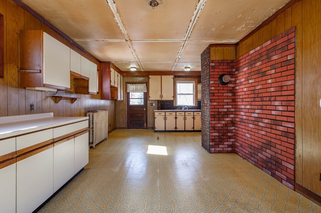34 Summer Street Saugus, MA 01906 - Photo 15 of 35 a kitchen with stainless steel appliances wooden cabinets a stove and a refrigerator