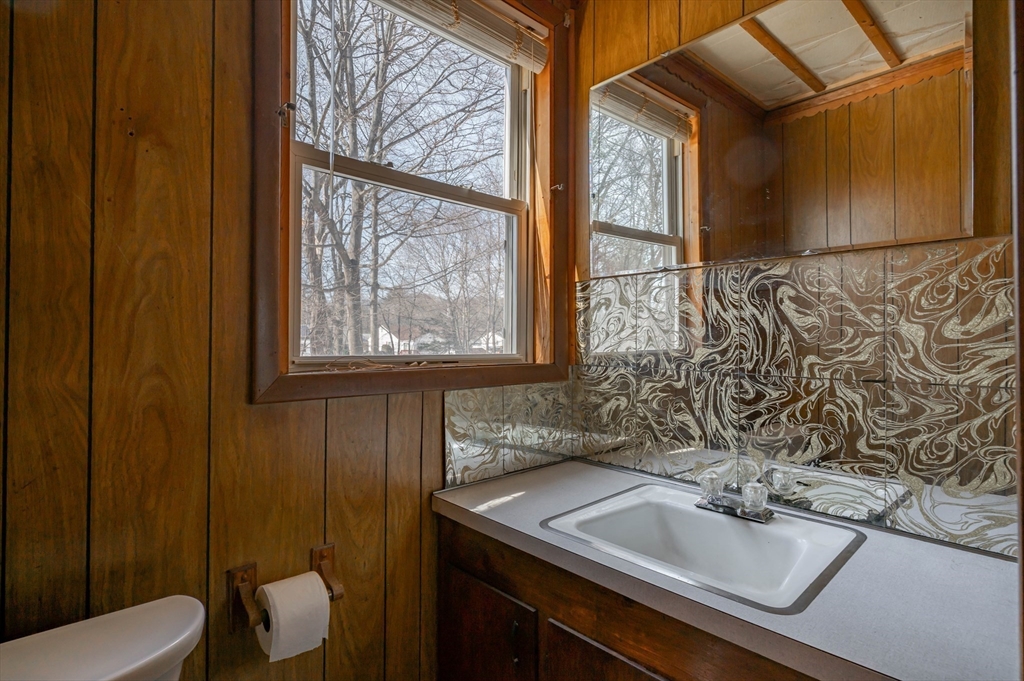 34 Summer Street Saugus, MA 01906 - Photo 19 of 35 a bathroom with a sink and mirror with toilet