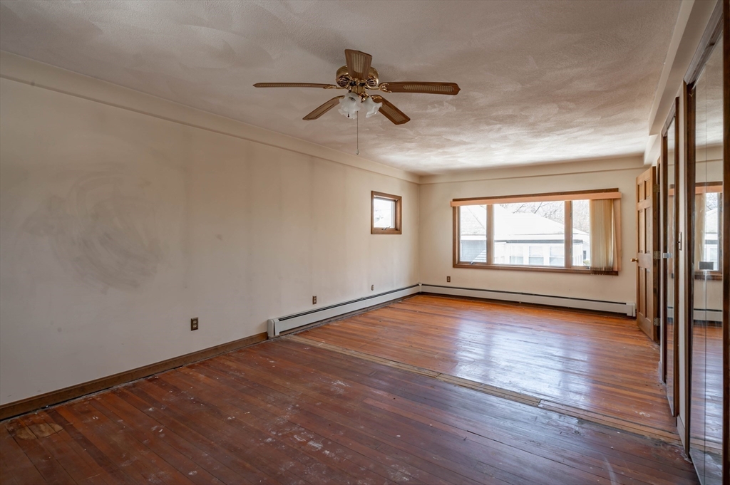 34 Summer Street Saugus, MA 01906 - Photo 23 of 35 an empty room with wooden floor fan and windows