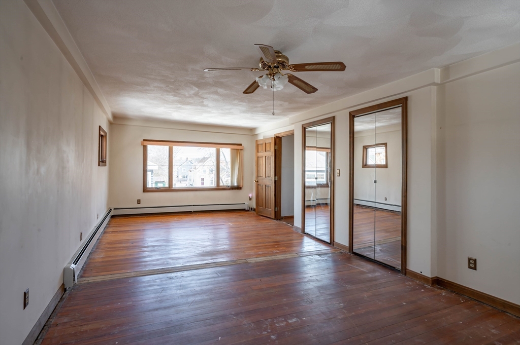 34 Summer Street Saugus, MA 01906 - Photo 24 of 35 an empty room with wooden floor fan and windows