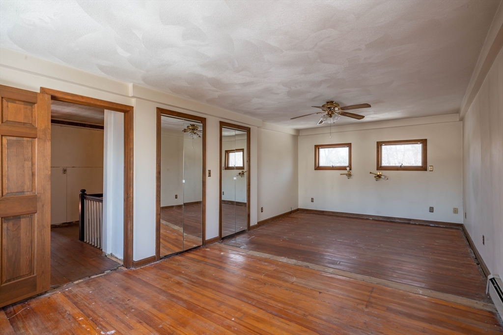 34 Summer Street Saugus, MA 01906 - Photo 25 of 35 a view of an empty room with wooden floor and a window