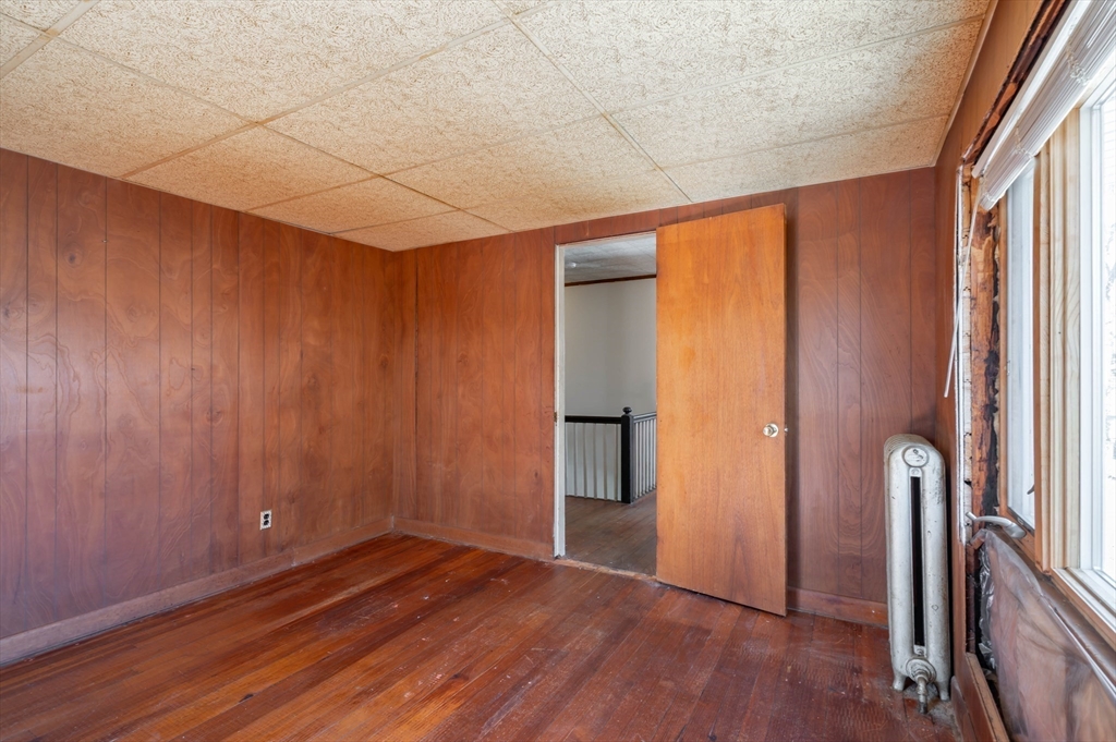 34 Summer Street Saugus, MA 01906 - Photo 28 of 35 a view of an empty room with wooden floor and a window