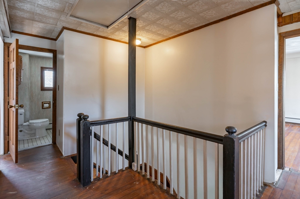 34 Summer Street Saugus, MA 01906 - Photo 29 of 35 a view of a hallway with the wooden floor and stairs