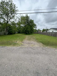 a view of a field with a tree in the background