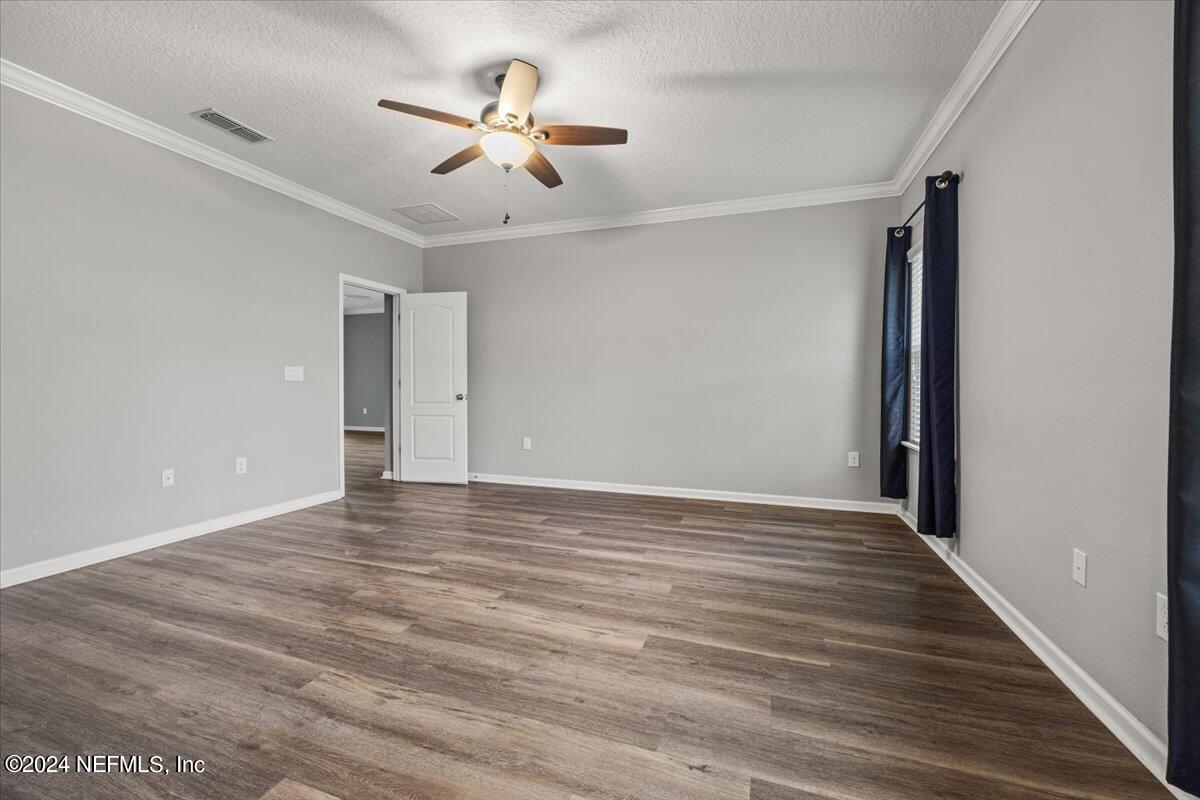 13 Pantano Vista Way St. Augustine, FL 32095 - Photo 14 of 25 a view of an empty room with wooden floor and a ceiling fan