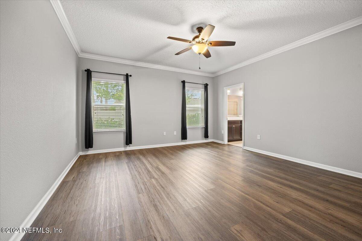 13 Pantano Vista Way St. Augustine, FL 32095 - Photo 15 of 25 an empty room with wooden floor and chandelier fan