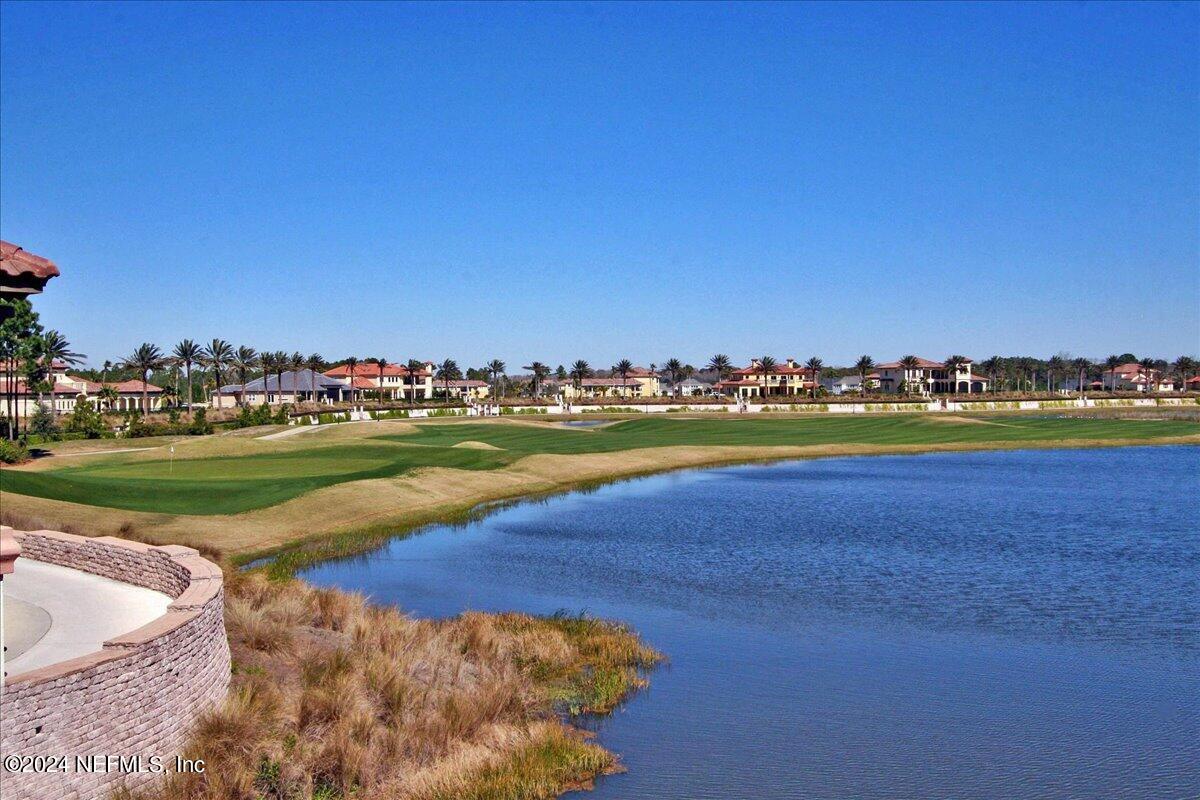 13 Pantano Vista Way St. Augustine, FL 32095 - Photo 2 of 25 a view of a swimming pool and lake in the back